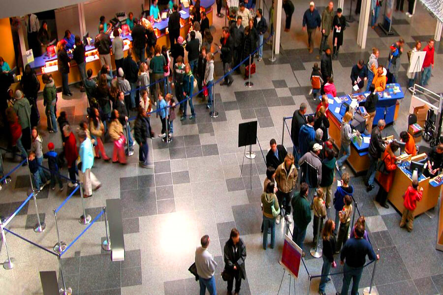 Professional queue management system with organized visitor lines at corporate event